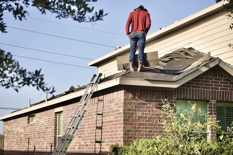 Professional roofer working on a residential roof in Platinum Triangle